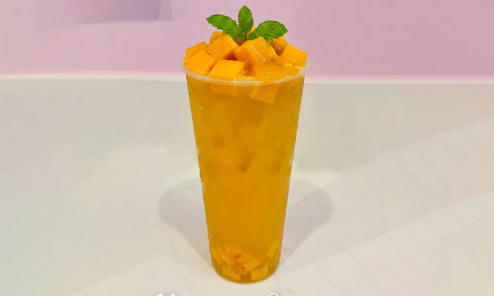 Iced mango smoothie loaded with fresh mango chunks at Lanikai BBQ Tea House, a Asian Fusion Restaurant in San Francisco